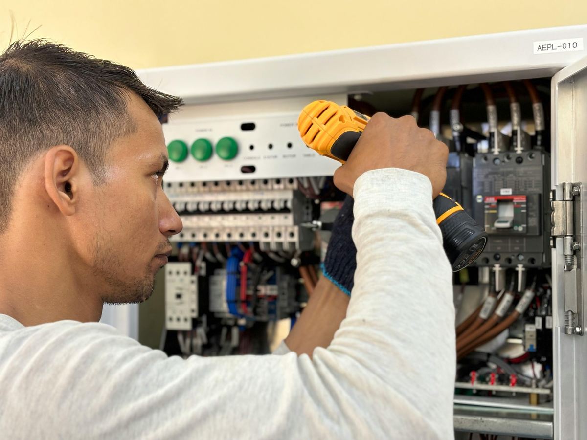 Electrician working on commercial electrical panel